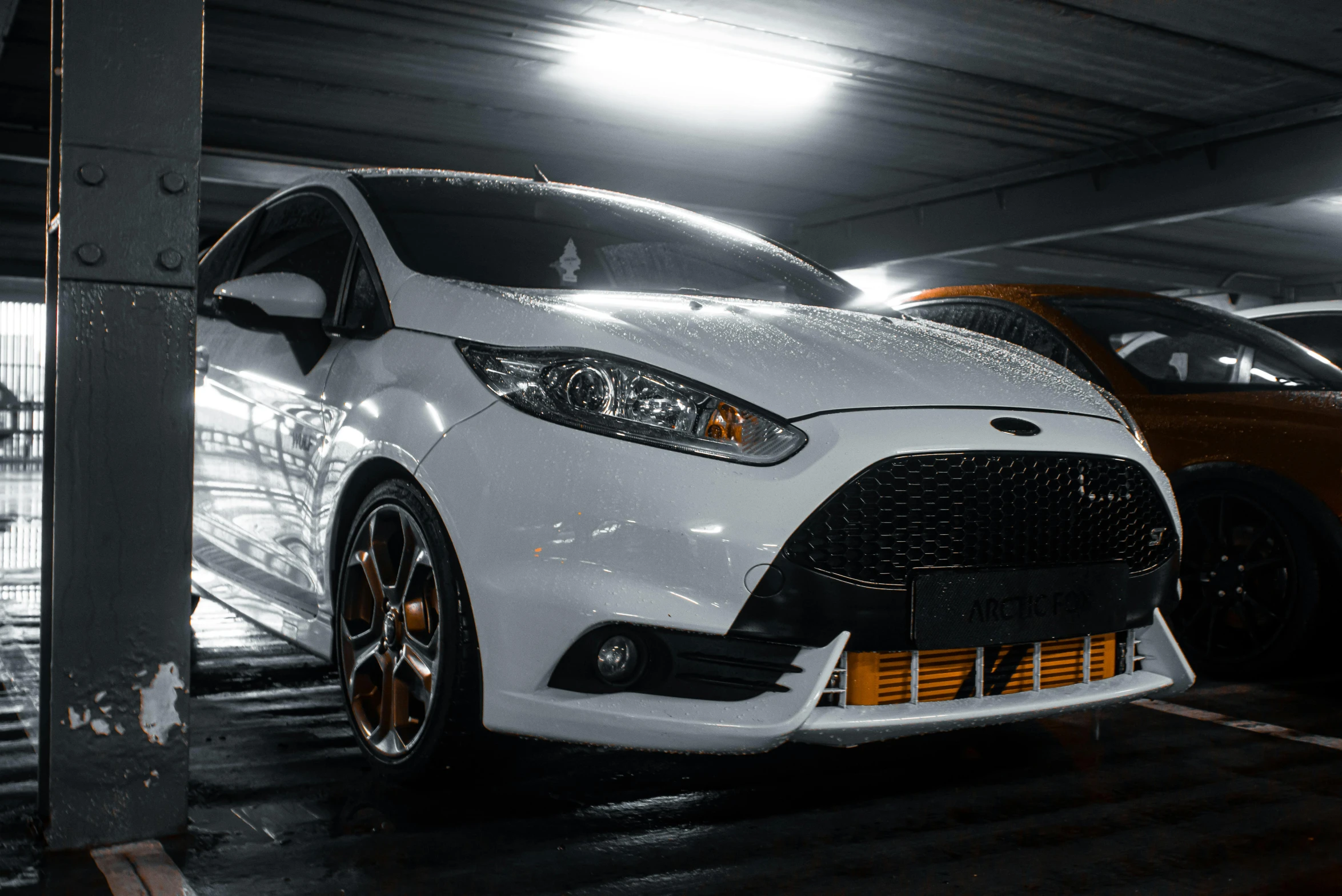 two different styles of cars parked in a garage