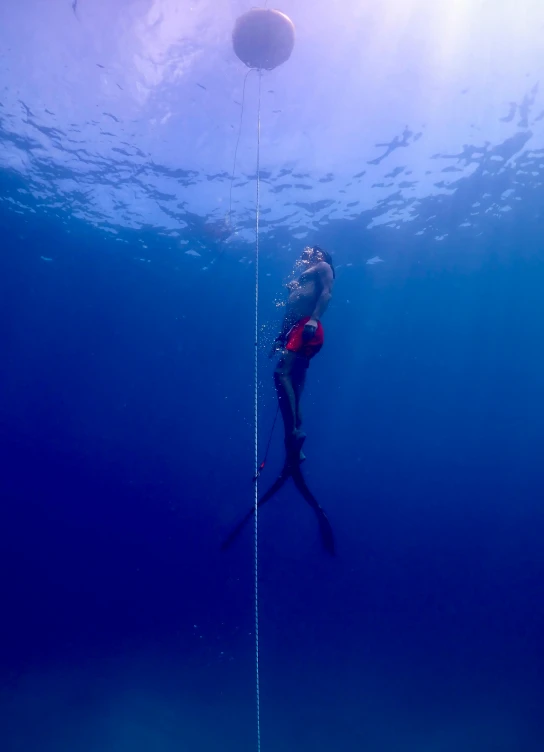 a person using a rope while underwater diving