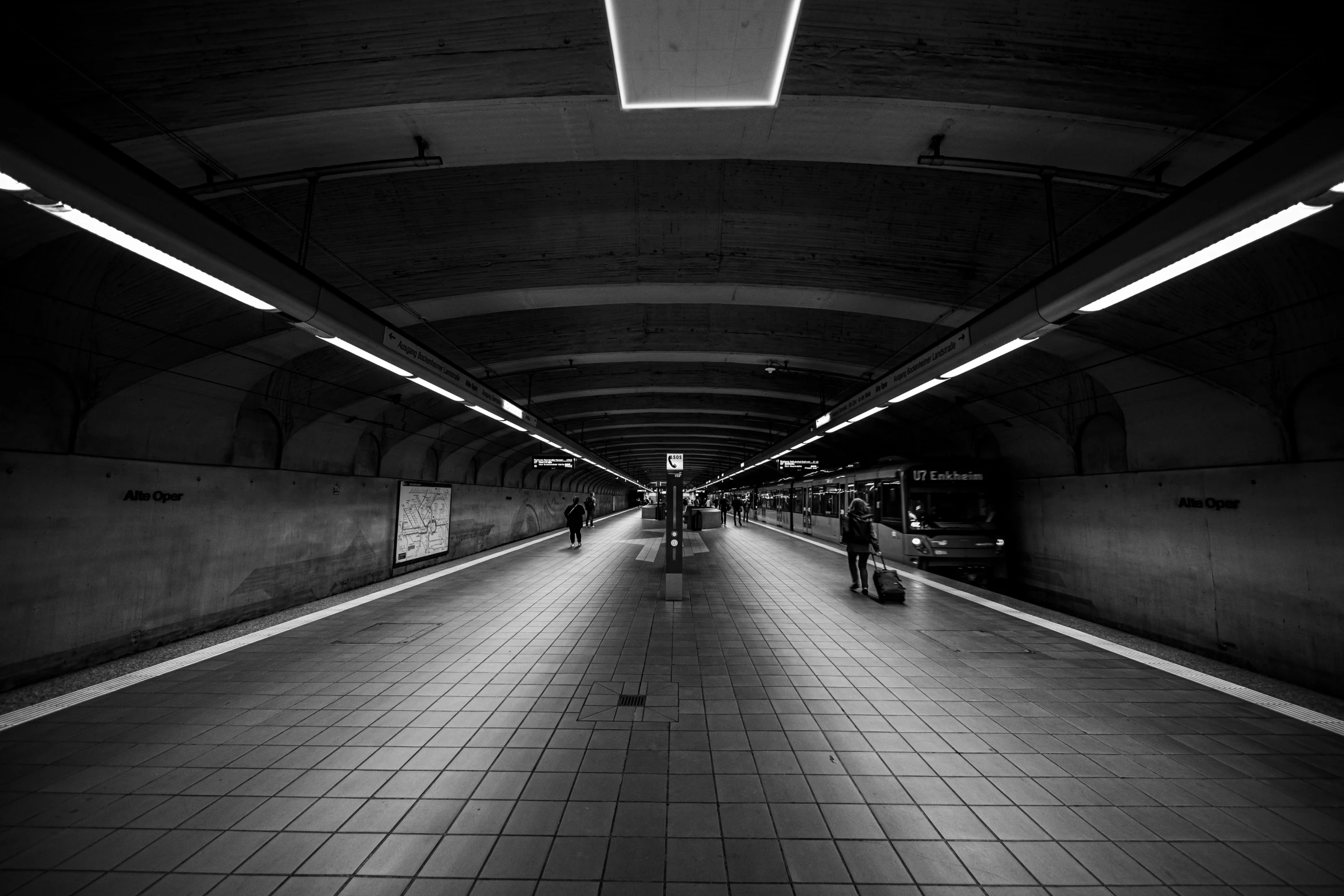 there are people walking in an underground tunnel