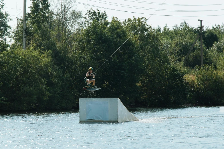 a person jumping in the air on a surfboard over water