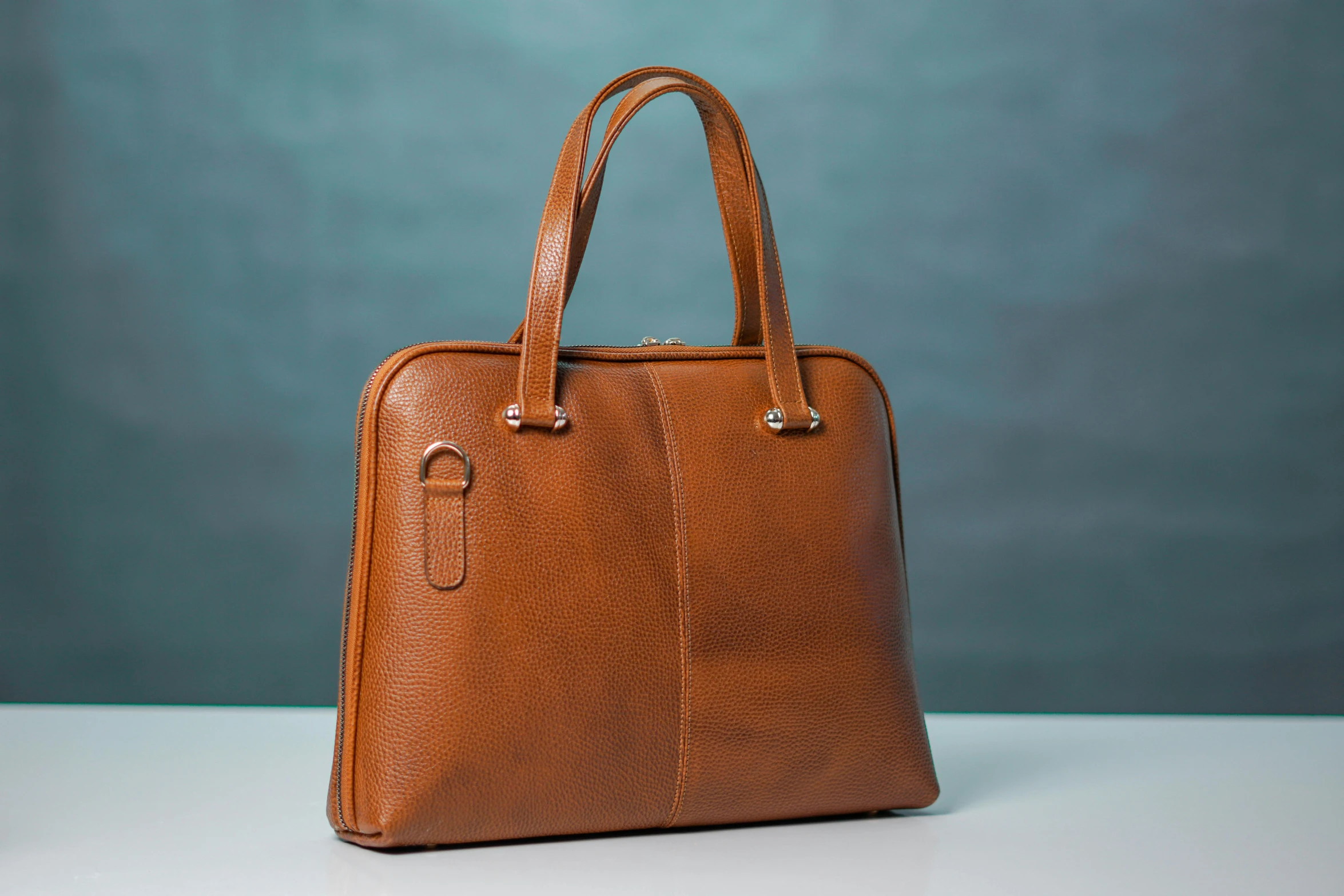 a brown colored leather briefcase on a table