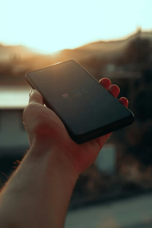 a person holding a cell phone in their hand