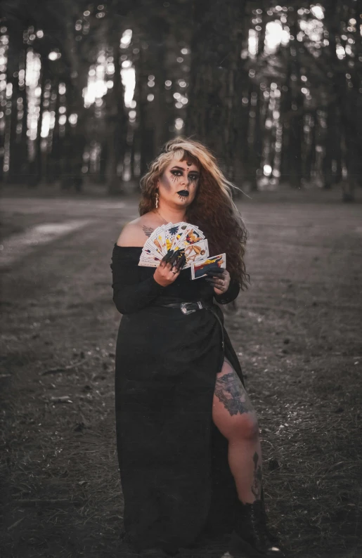 a woman with makeup holding a knife and looking at her face