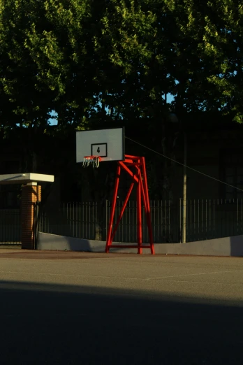 a basketball goal on the side of the street