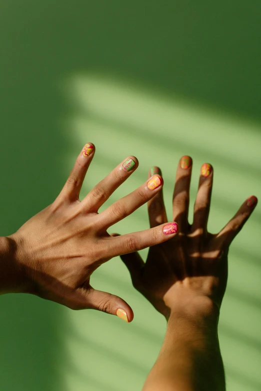 the hands have different nail designs on them