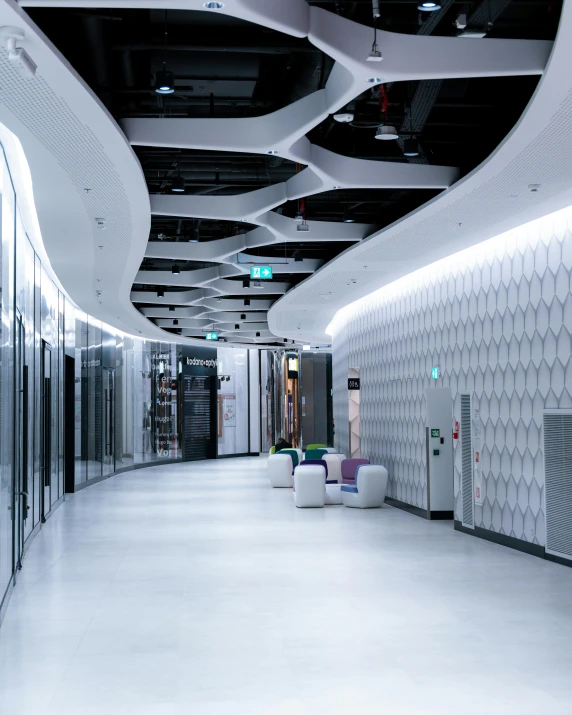 a large empty hallway with white tile walls