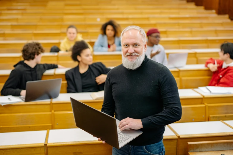 the man is standing in front of some lecture hall