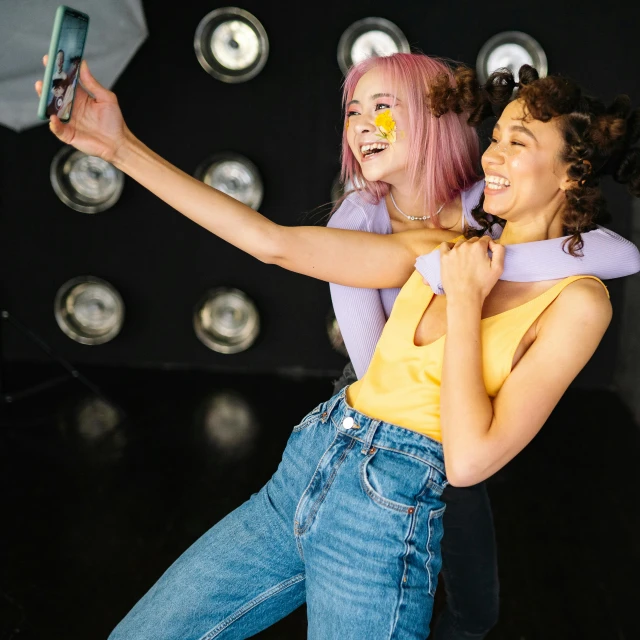 two girls smile as they perform at an event