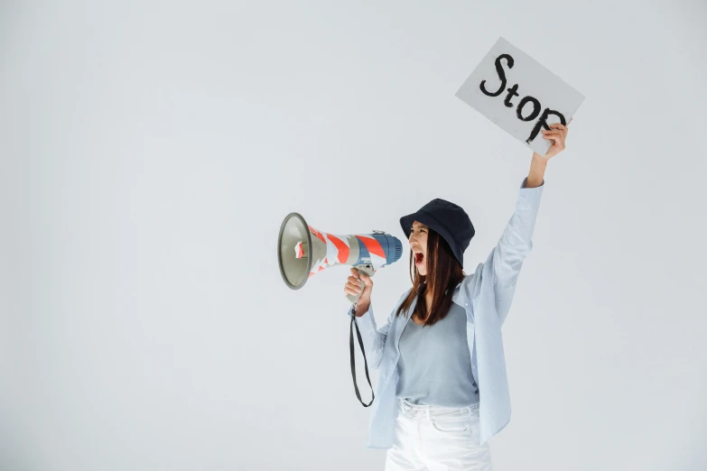 woman holding up a sign and a megaphone