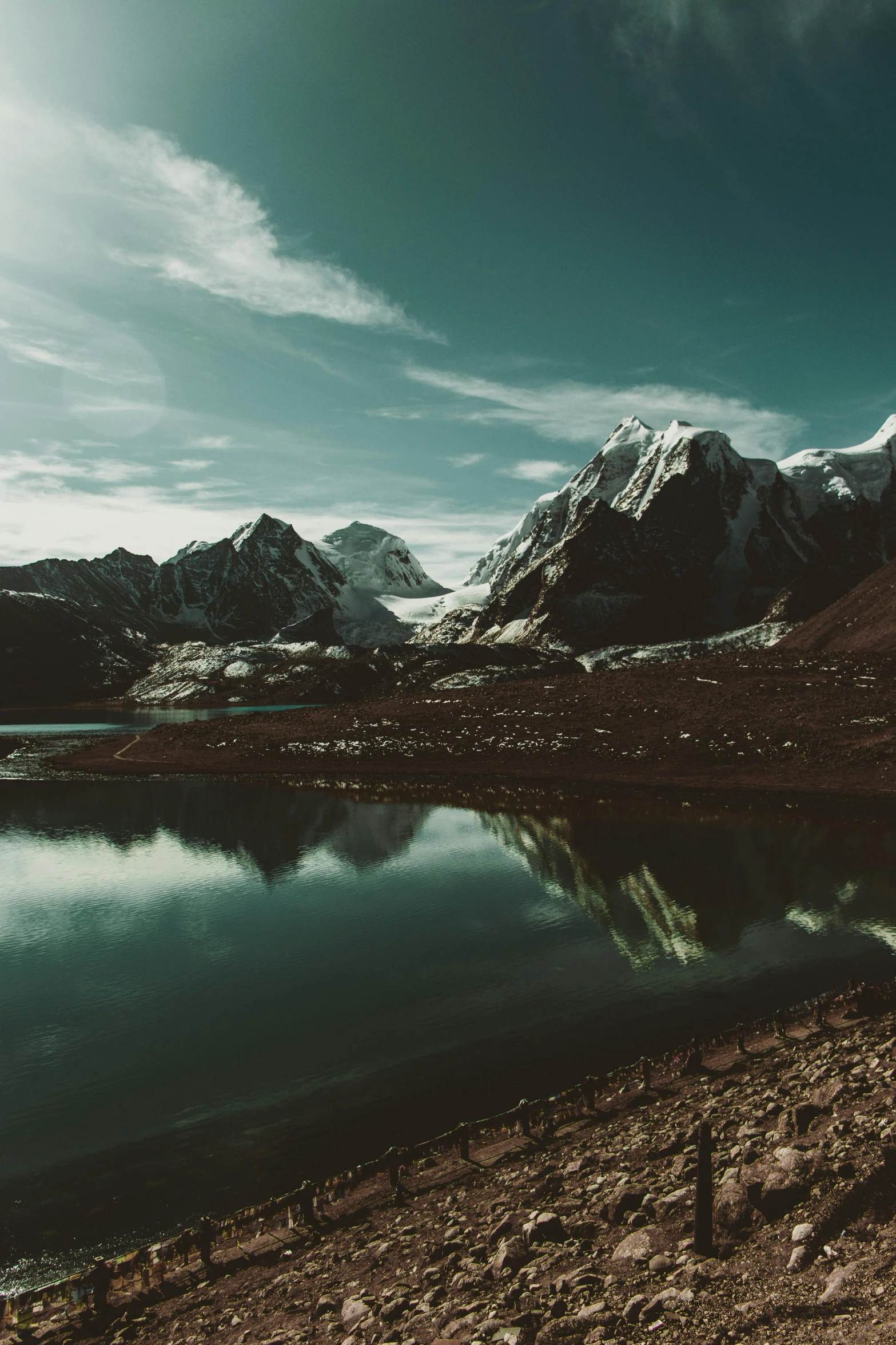 an image of a mountain range reflecting in the water