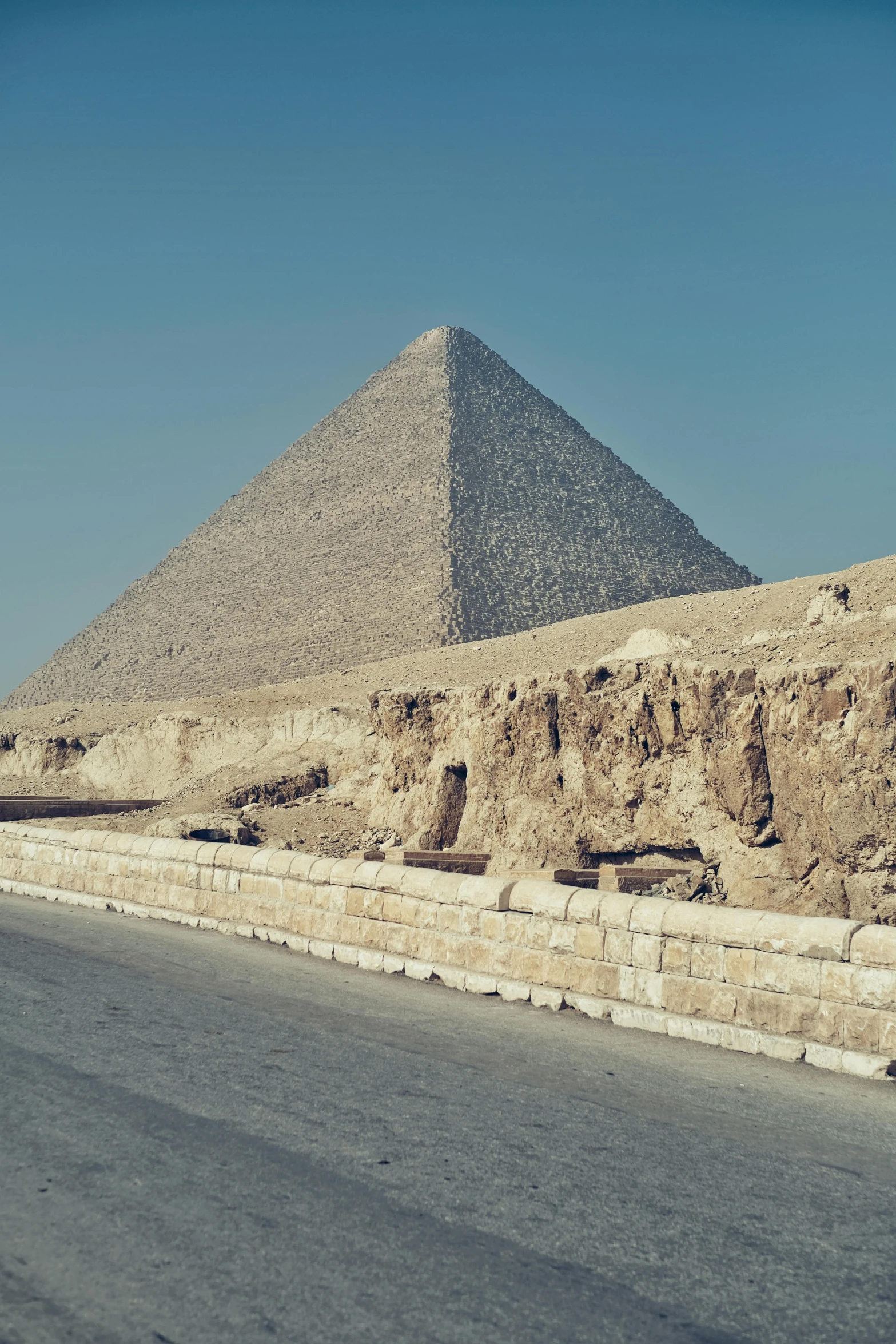 a long empty road near a large pyramid