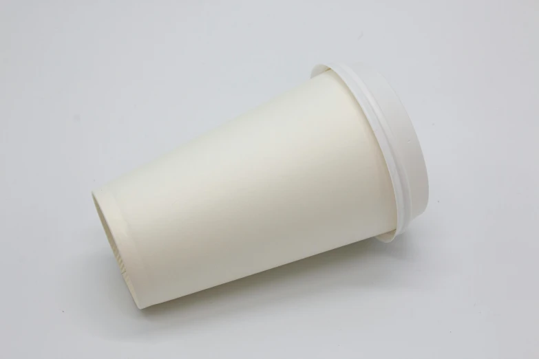 a white empty coffee cup on a light gray surface