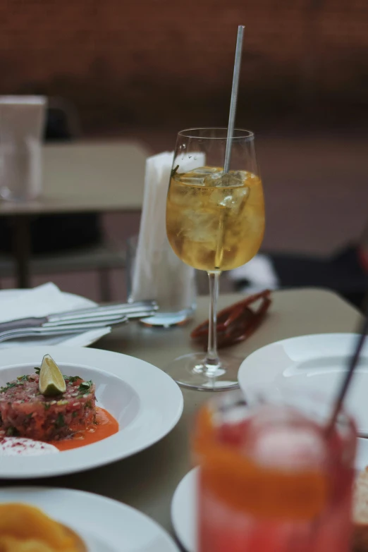 several plates and glasses of wine on the table