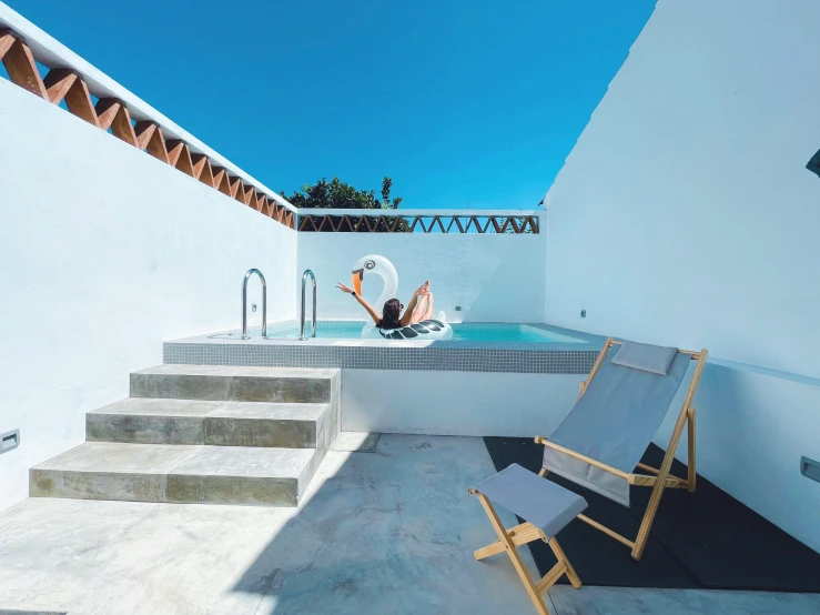 a  tub with lounge chair and an over head lounging bather sitting next to it