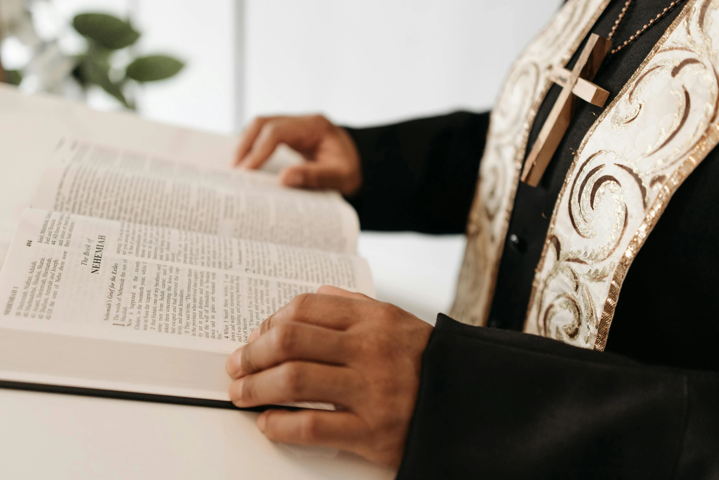 priest reading an old, religious book at the altar