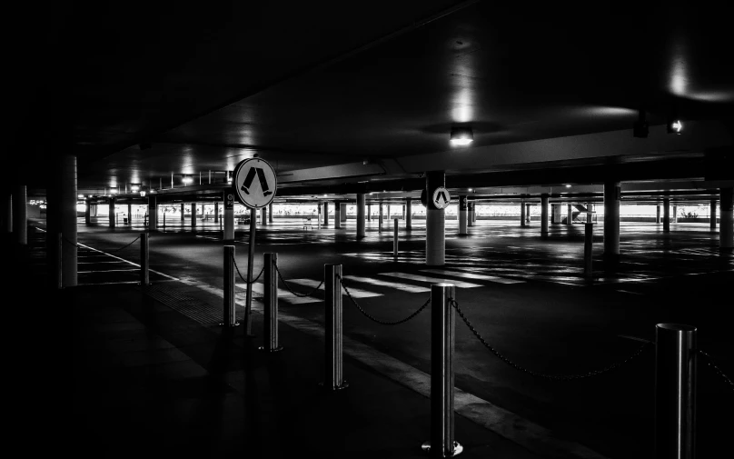 a stop sign in a parking garage at night