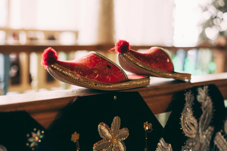 a pair of shoes sitting on top of a wooden counter