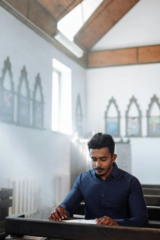 a man who is sitting in a church pew