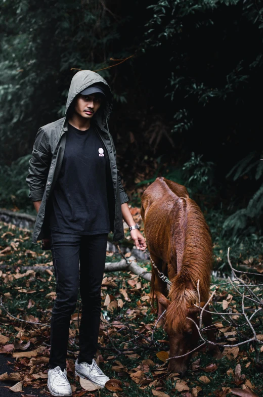 the man with his hand near the animal