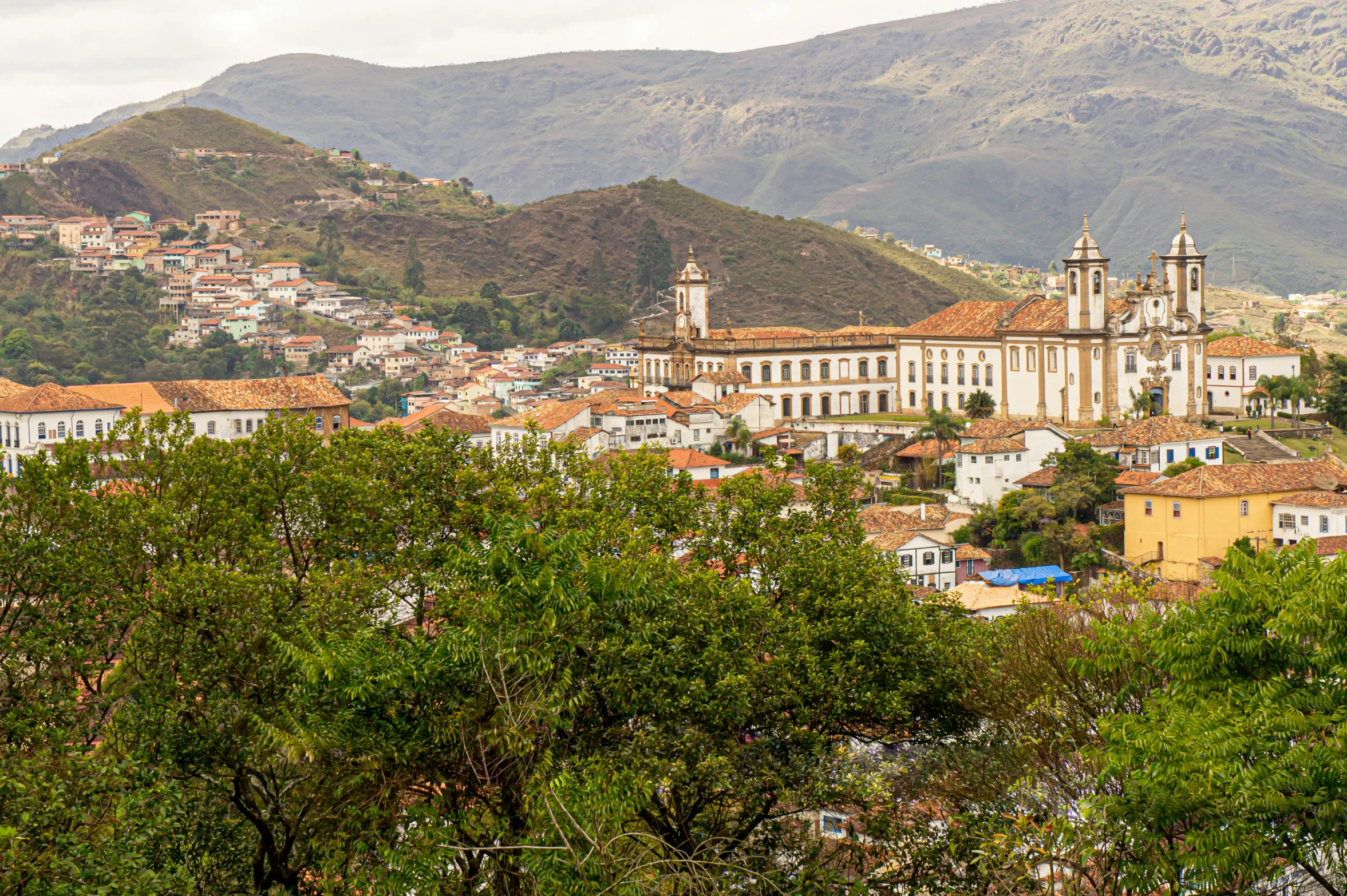 a city is in the foreground with mountains in the background