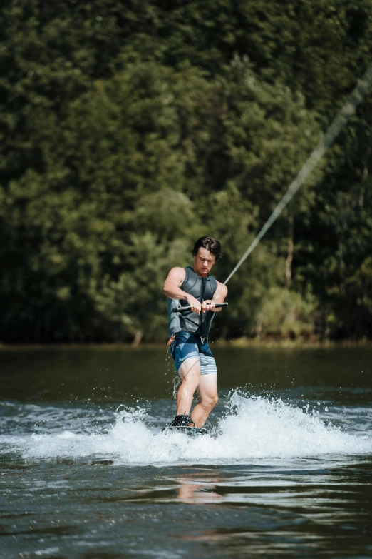 a man is water - skiing on a small body of water