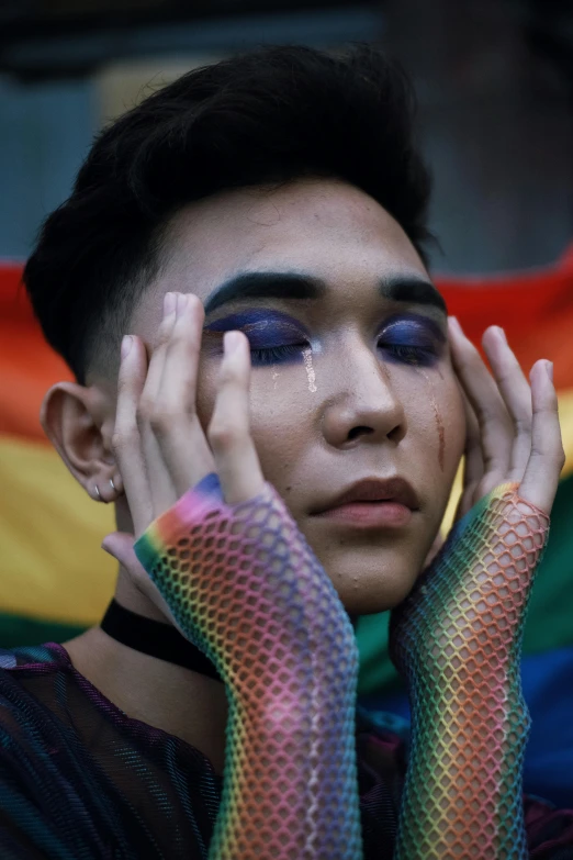 a person covered with makeup posing for the camera