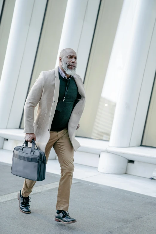 a bald man with a long beard holding his briefcase