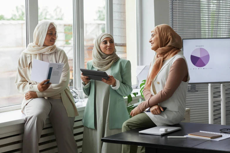 three women standing in a row reading notes