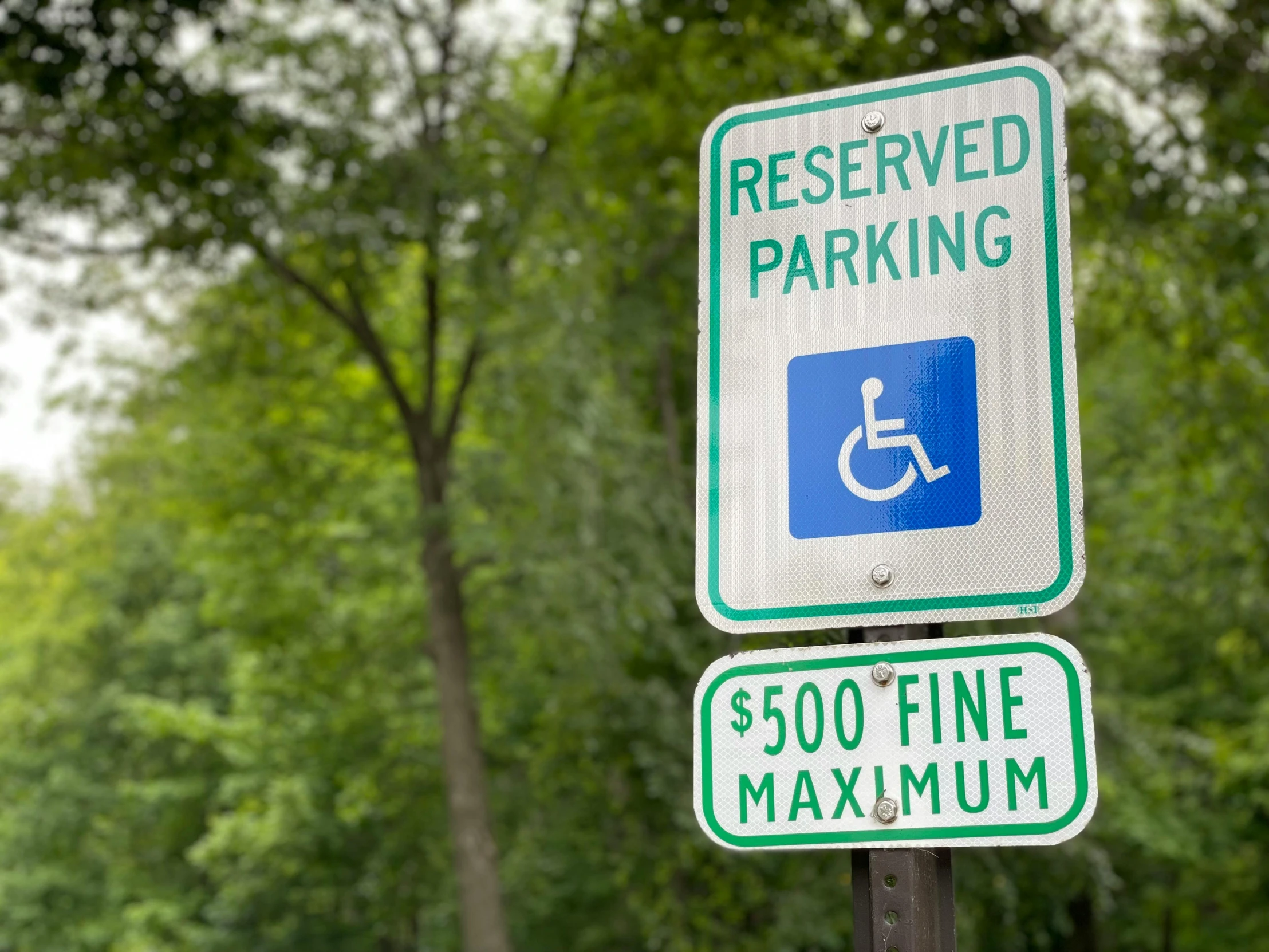 there are three signs indicating to handicap accessible parking