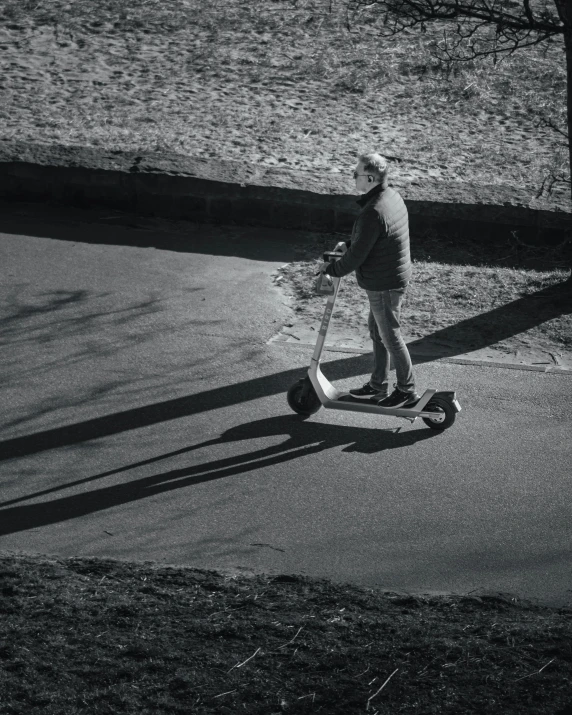 man riding a segway on a paved street