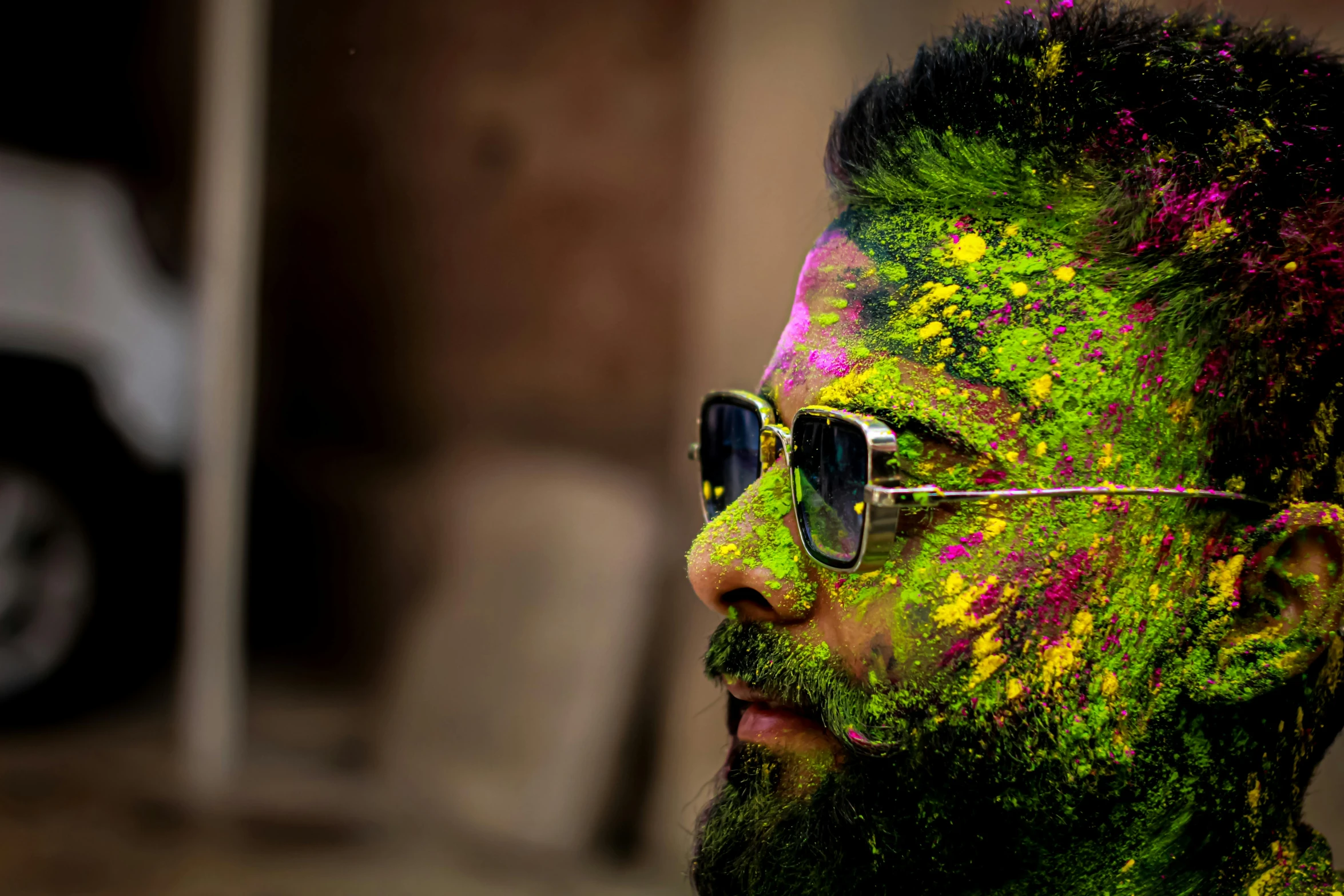 man with sunglasses on and green and yellow