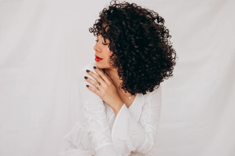 woman with curly afro hair posing for po