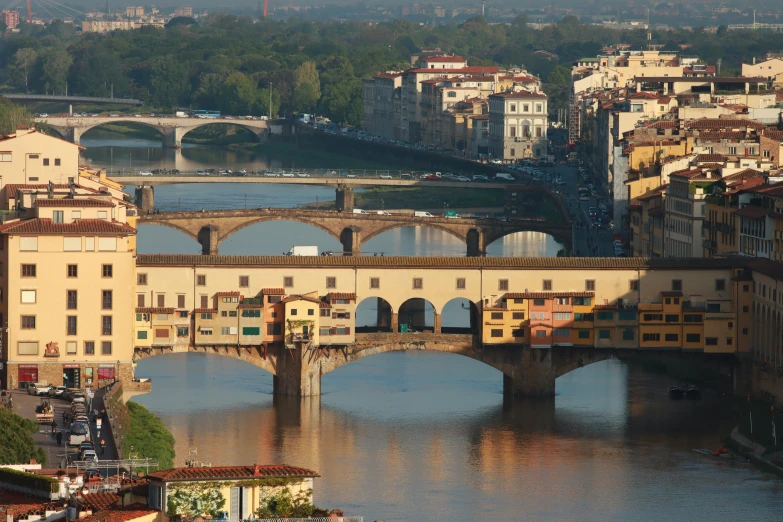 a view of a city across the water with bridge above