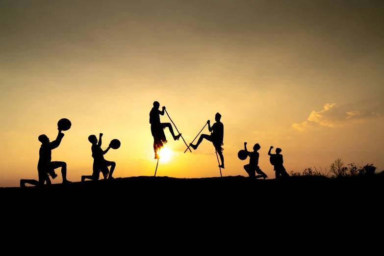 a group of people playing basketball in silhouette