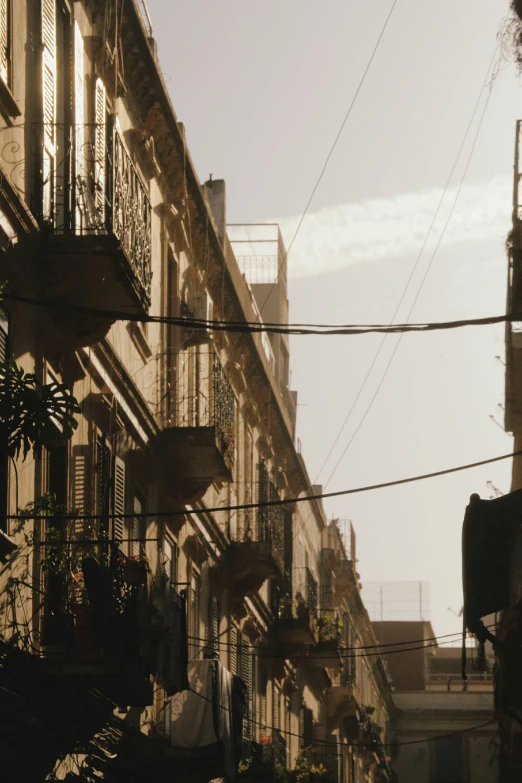 a building on the street is lit up by sunlight