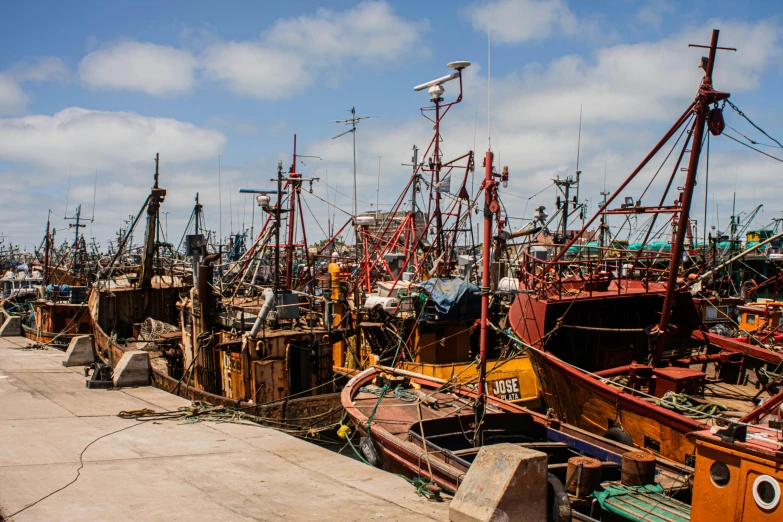 old boats sitting on the ground of a dock