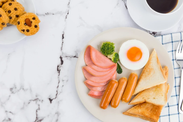 an egg, meat, and broccoli on a plate