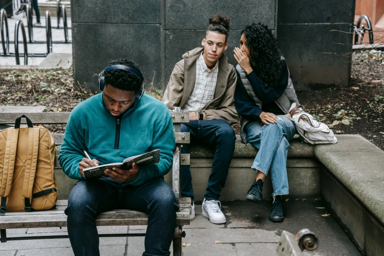 the three people are looking at the book