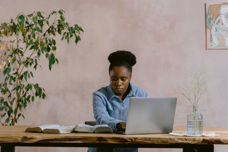 a woman at a table using a laptop computer