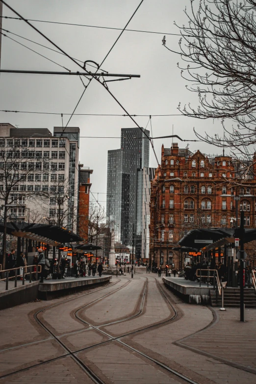 a city street with several buildings and wires