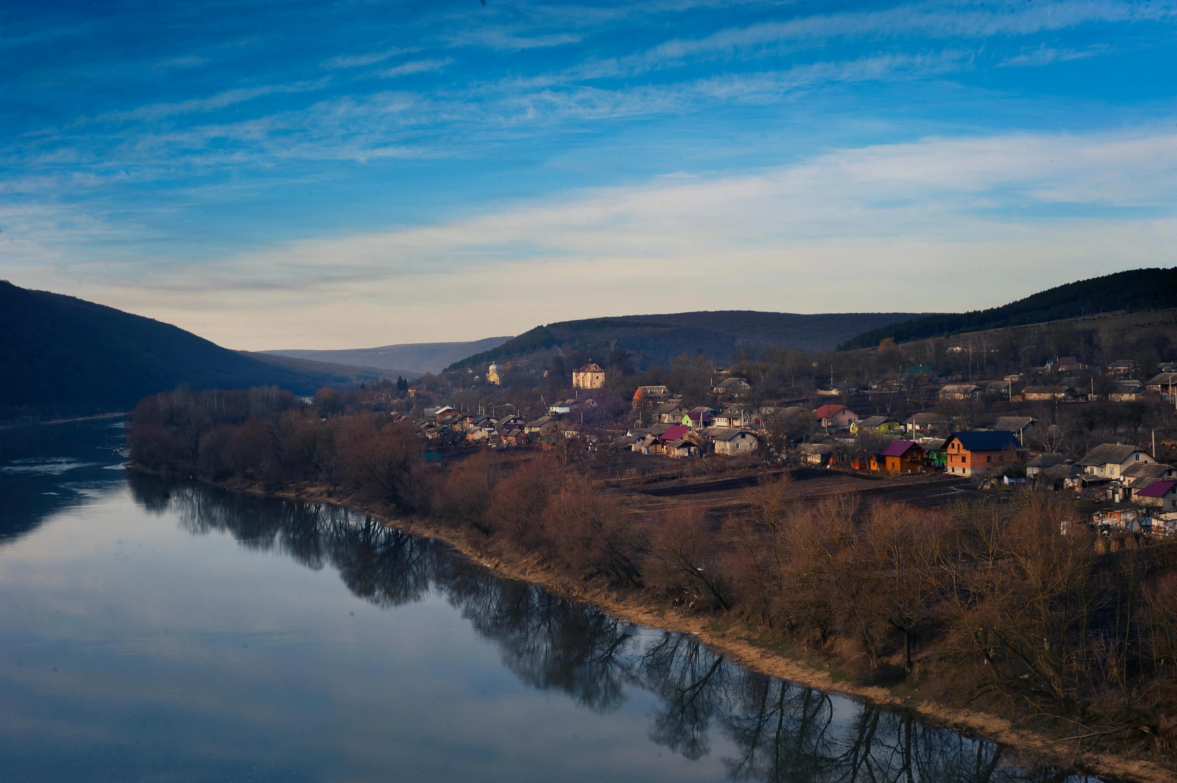 some houses along a river in a mountainous area