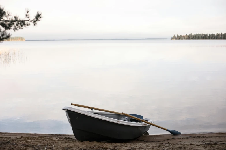 a boat that is sitting in the sand near the water