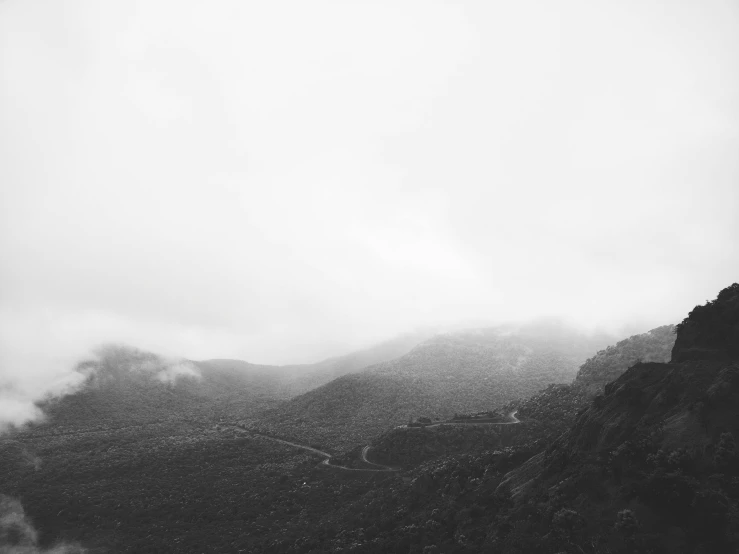 foggy mountain landscape with train tracks winding through