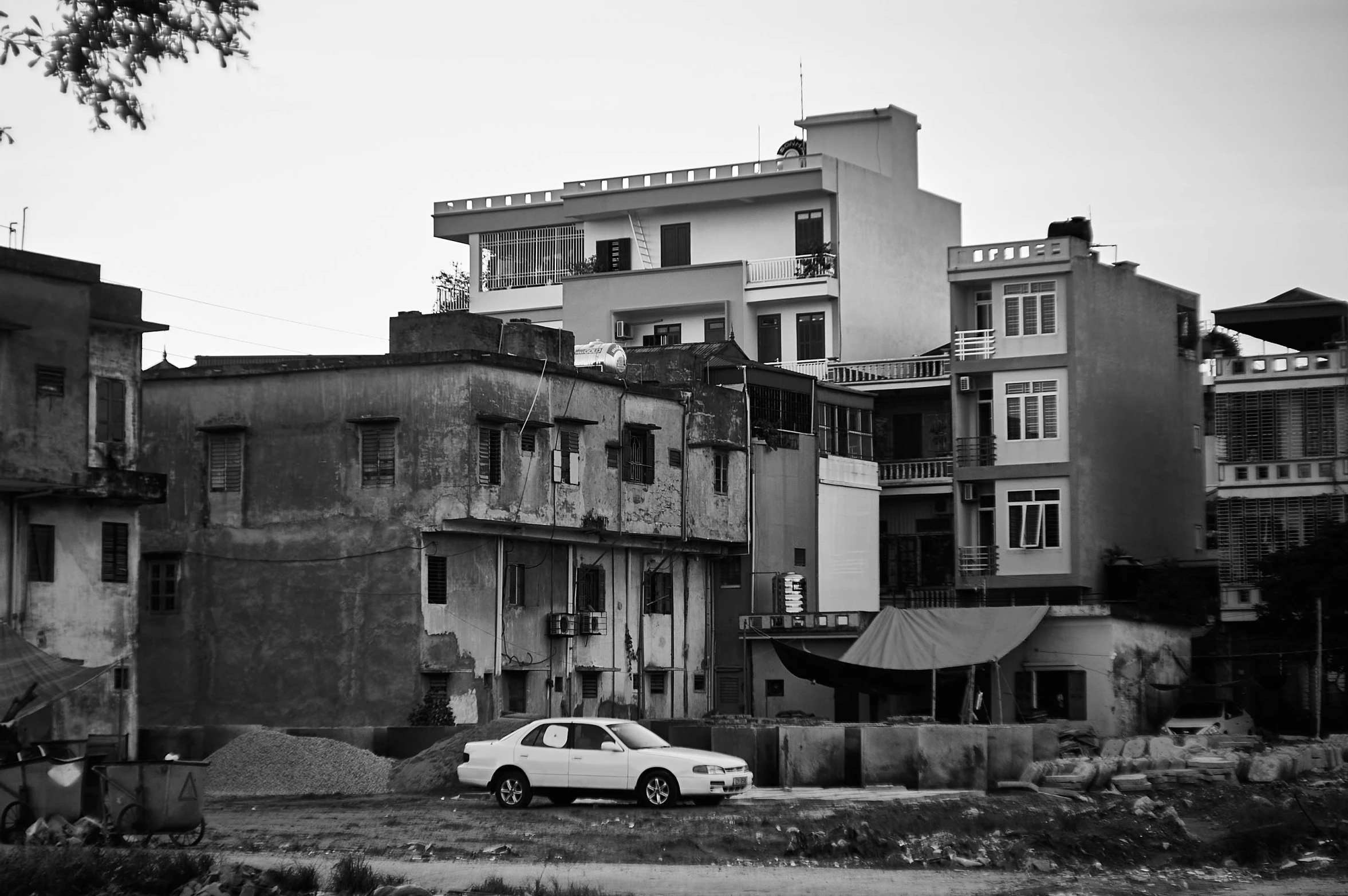 a white car parked in front of a very old building