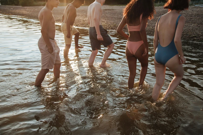 a group of people standing in the water together