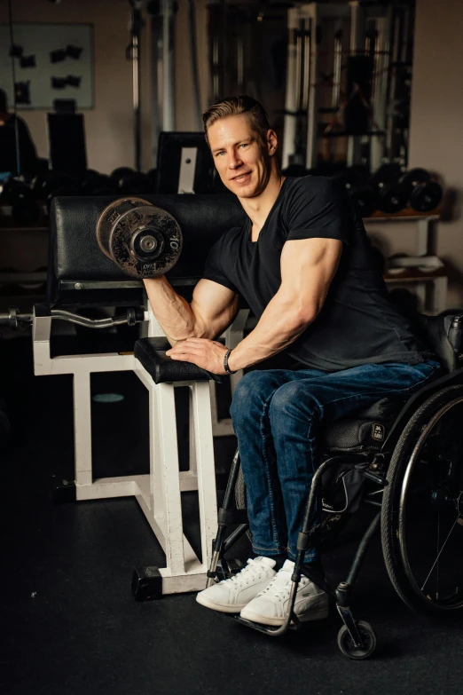 a man with leg cast sitting in his wheelchair holding a leg rest