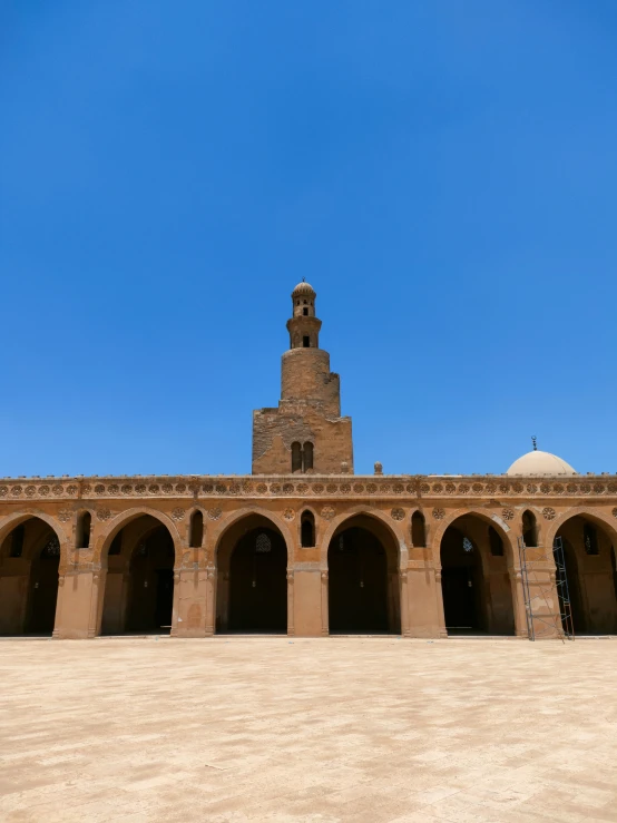 a large stone building surrounded by pillars and arches