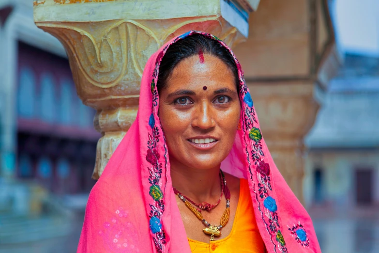 there is a woman wearing pink and yellow clothing