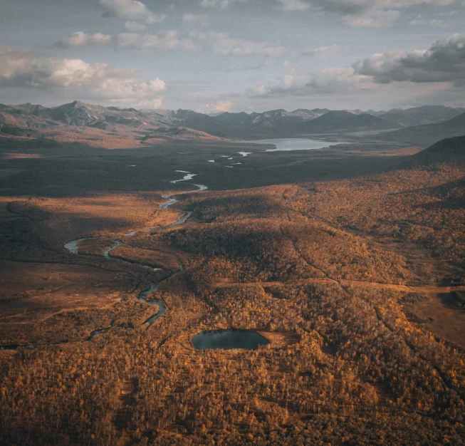 an image of aerial view of mountains and river