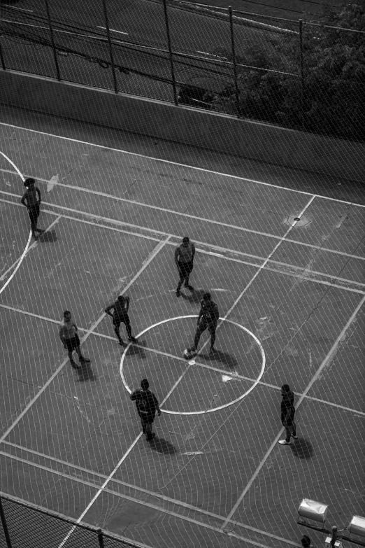 a group of men playing a game of basketball on a court